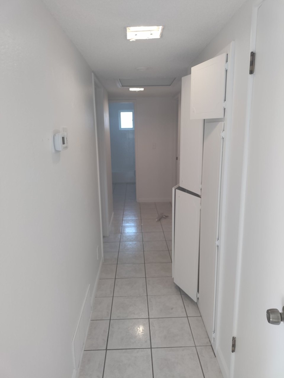 Interior hallway repaint with tile flooring protected